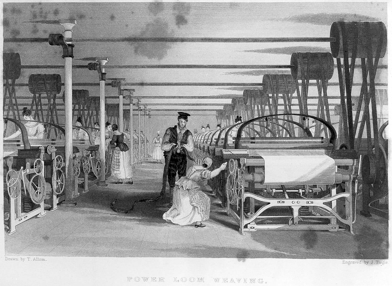 Power looms weaving fabric in a textile mill