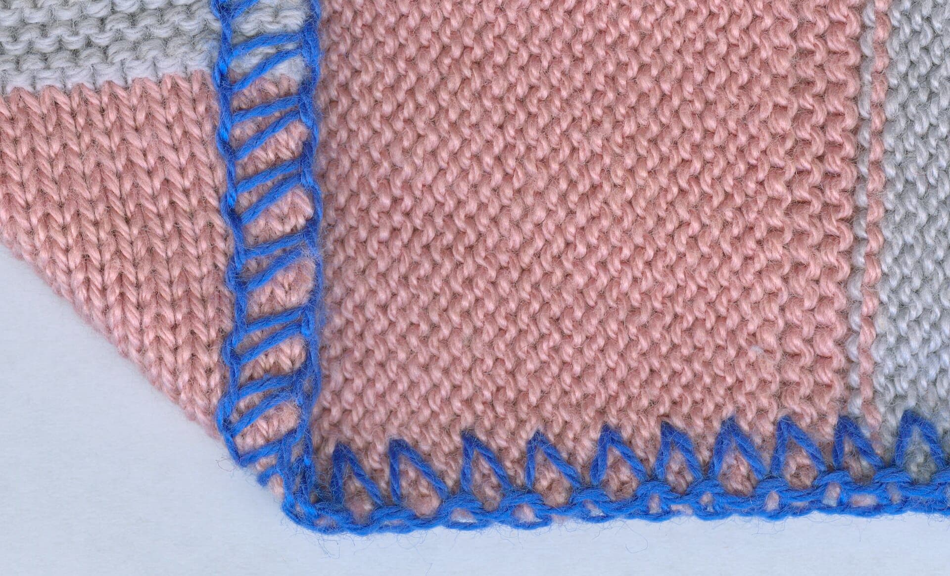 Close-up of clothing being sewn on an industrial machine