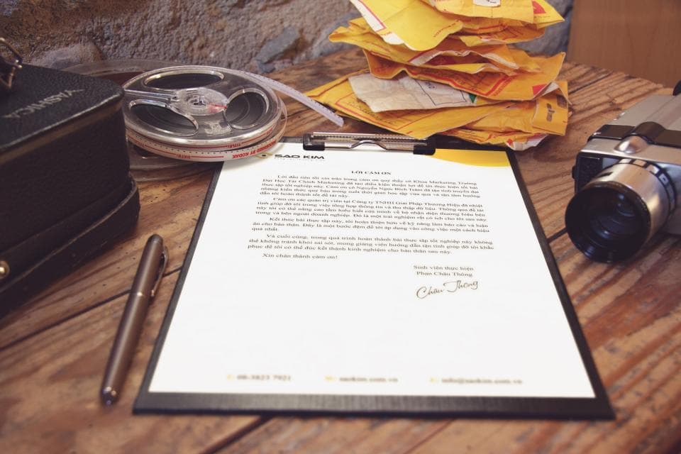 Manual paperwork and spreadsheets on an office desk in a textile business