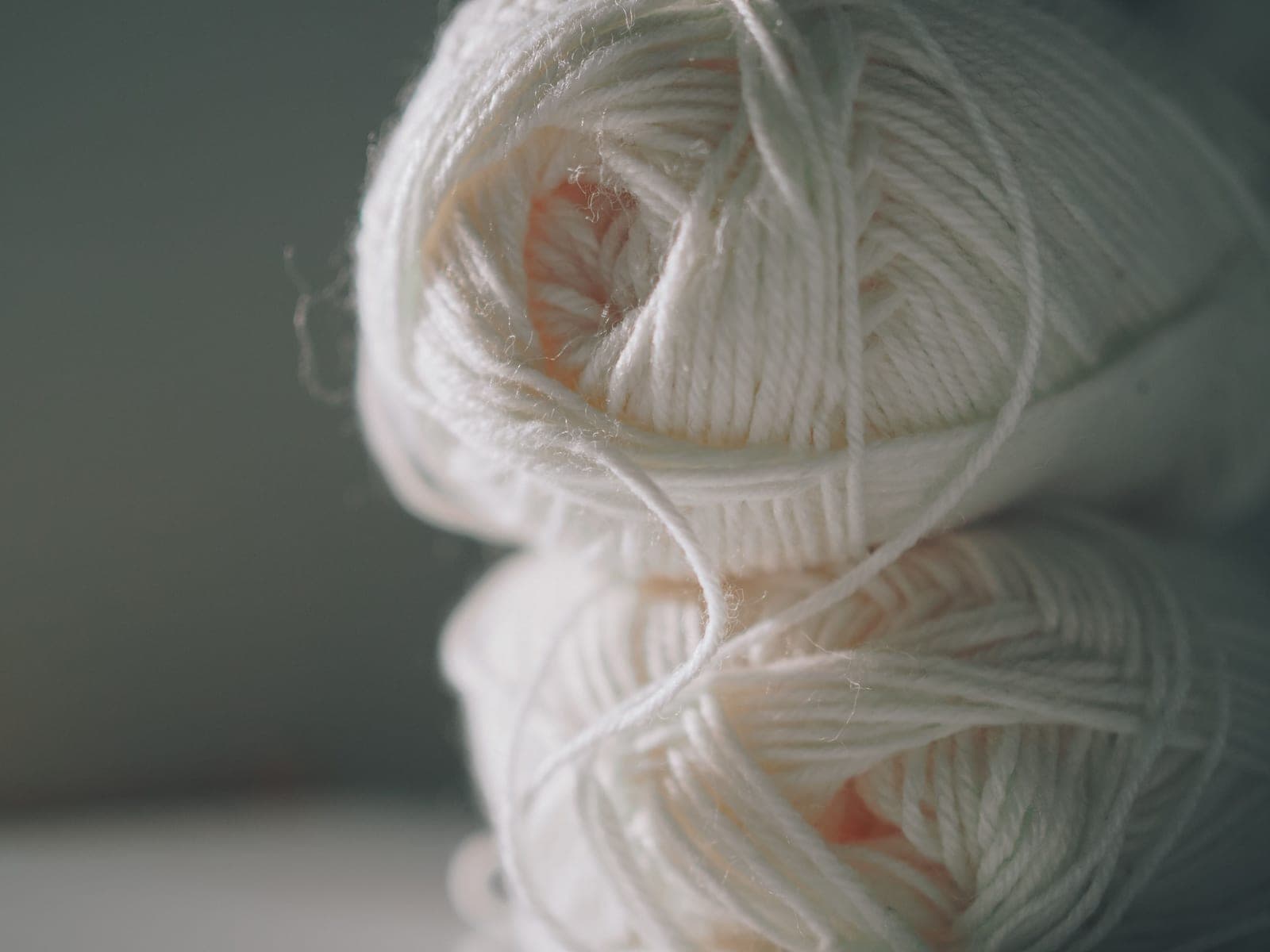 Soft white combed cotton yarn balls stacked closely together