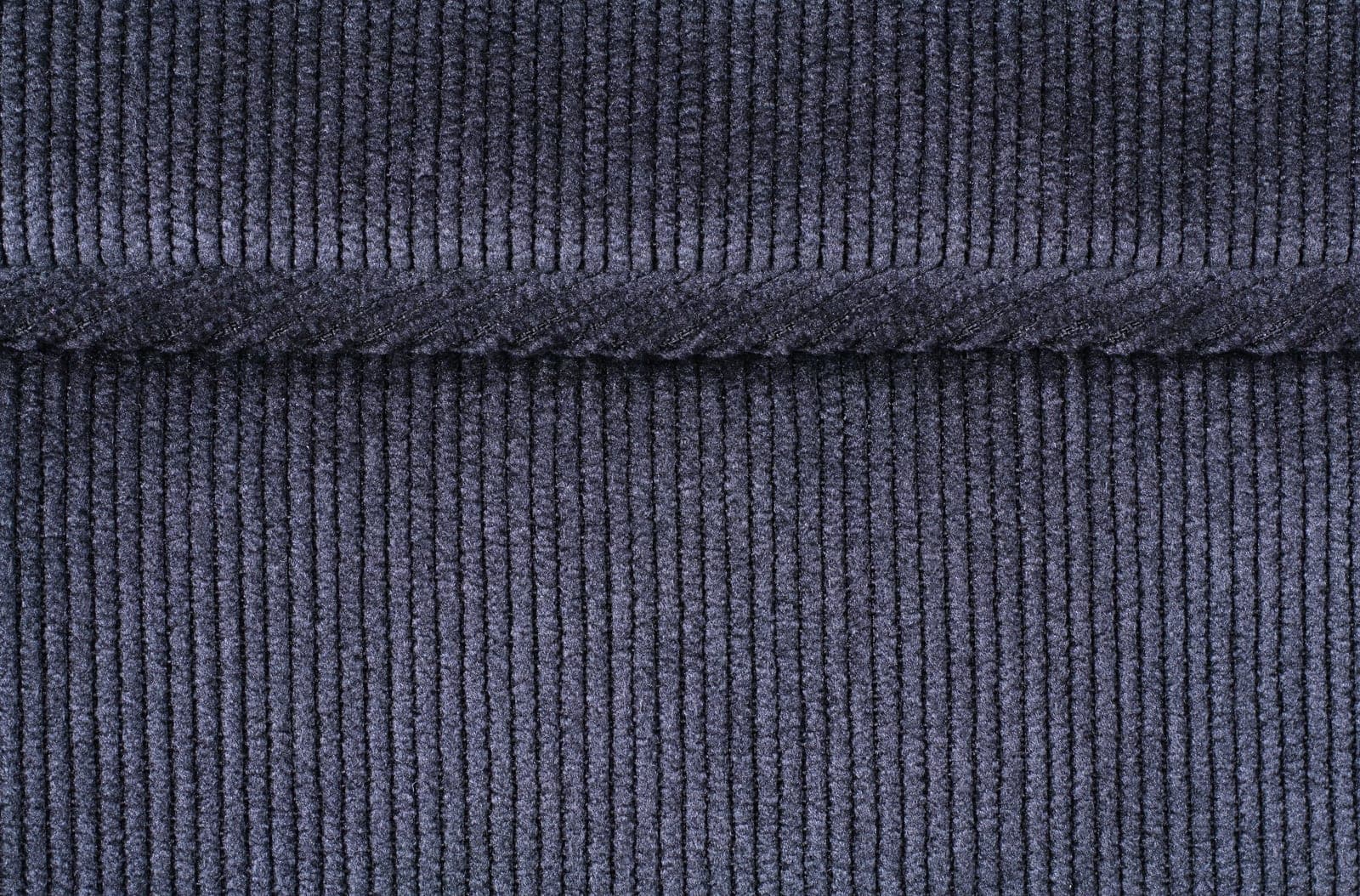 Close-up of blue corduroy fabric showing the distinctive vertical wale ridges