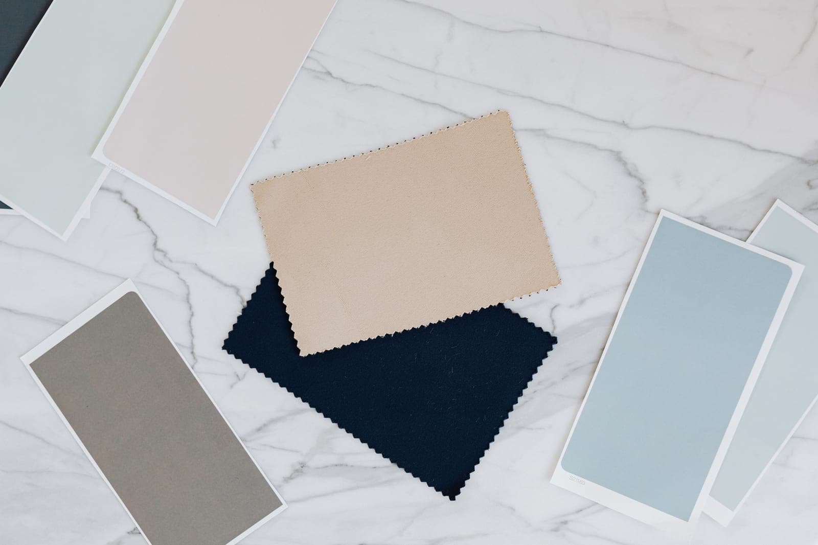 Fabric colour swatches and shade-card samples laid out, used to agree and control textile colour