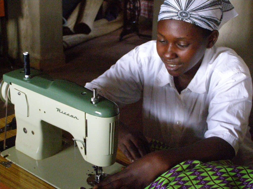 Entrepreneur starting a small textile business among rolls of fabric