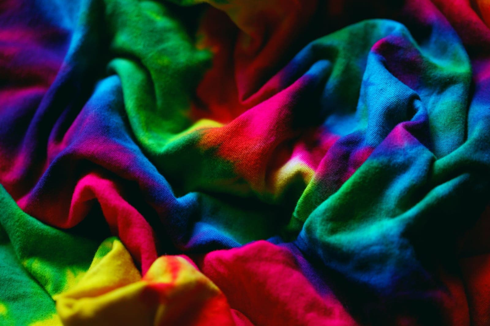 Vibrant multicoloured tie-and-dye fabric in rainbow shades