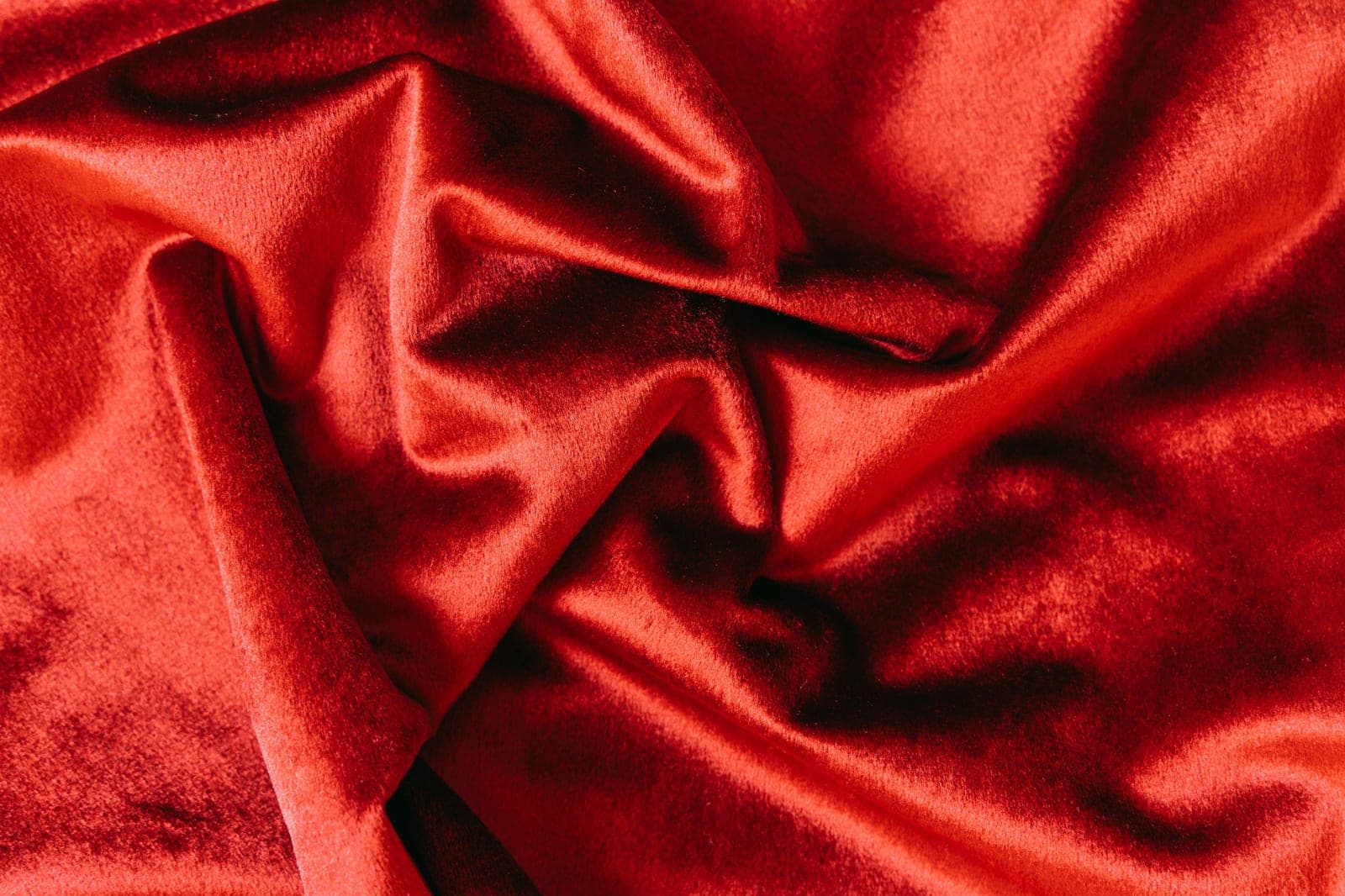 Rich red velvet fabric showing the soft pile and sheen characteristic of velvet