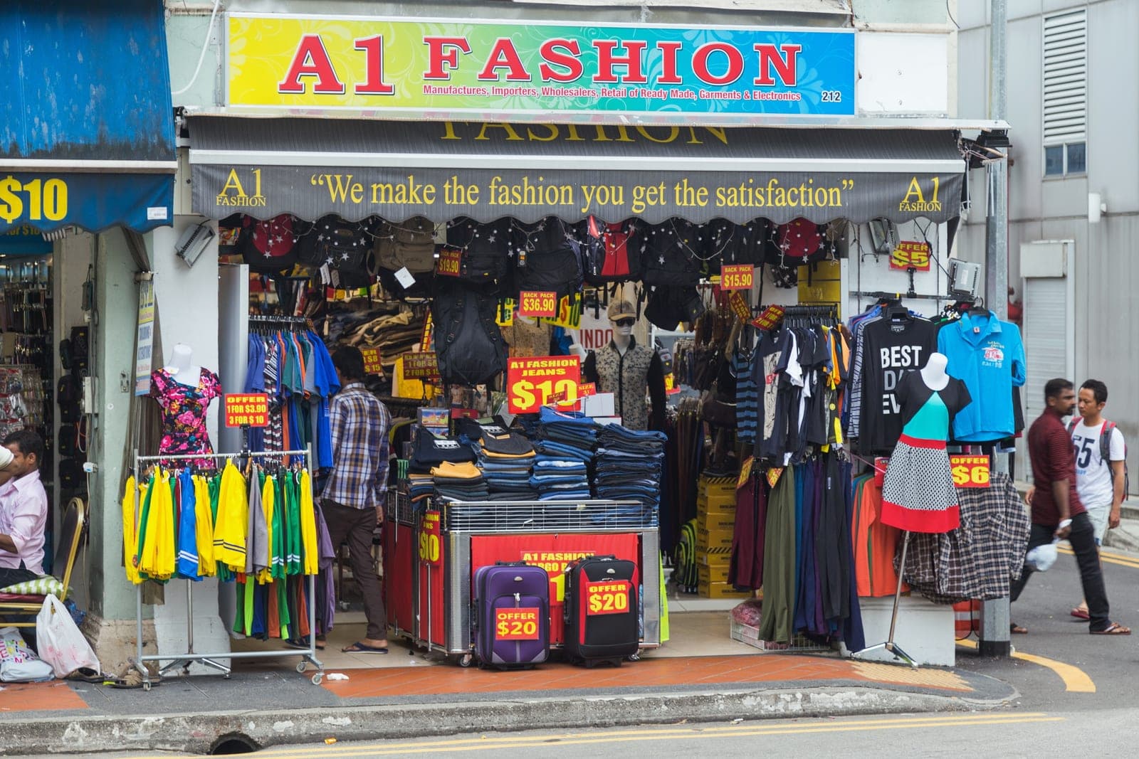 Readymade garment retail shopfront displaying shirts, jeans and trousers with price tags