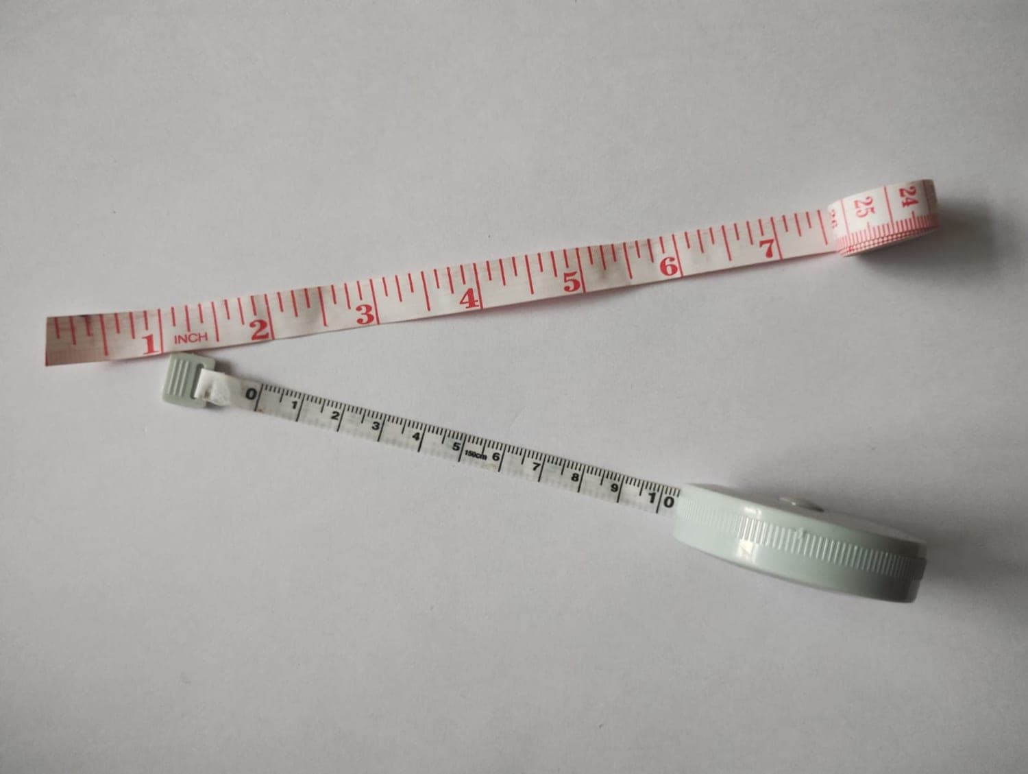 Tailor's measuring tapes in inches and centimetres for recording customer measurements