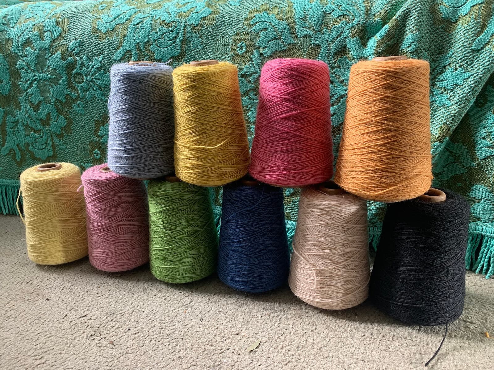Cones of coloured yarn stocked in a textile warehouse tracked by textile ERP software